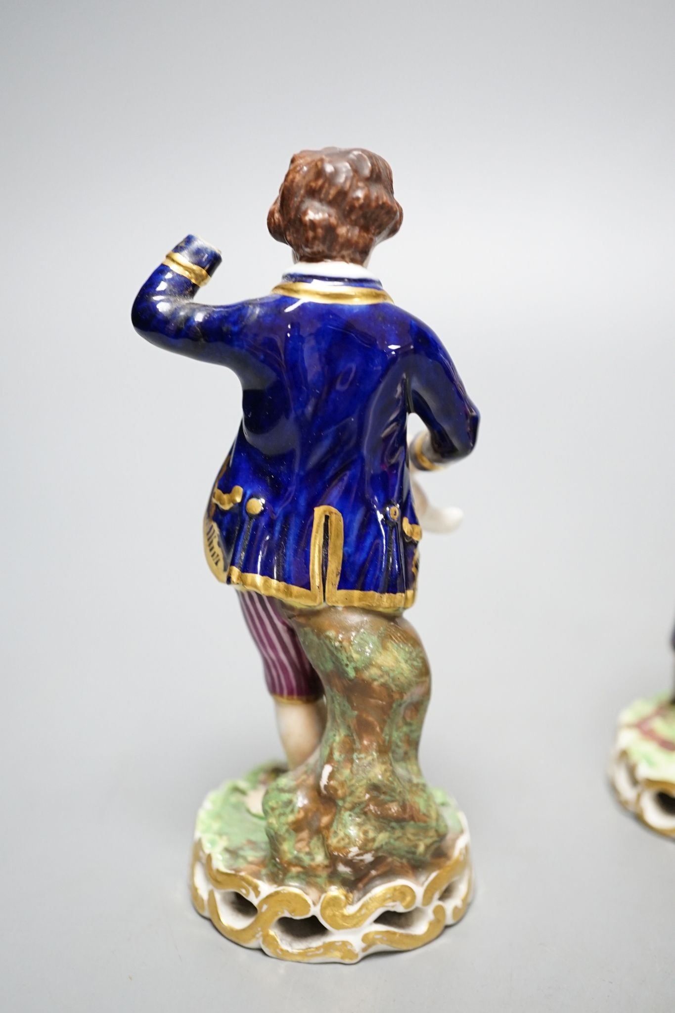 A Minton porcelain figure of a lady seated with a dog c.1830, a pair of Derby figures of a girl and a boy with a dog and a sheep, and a Bloor Derby vase